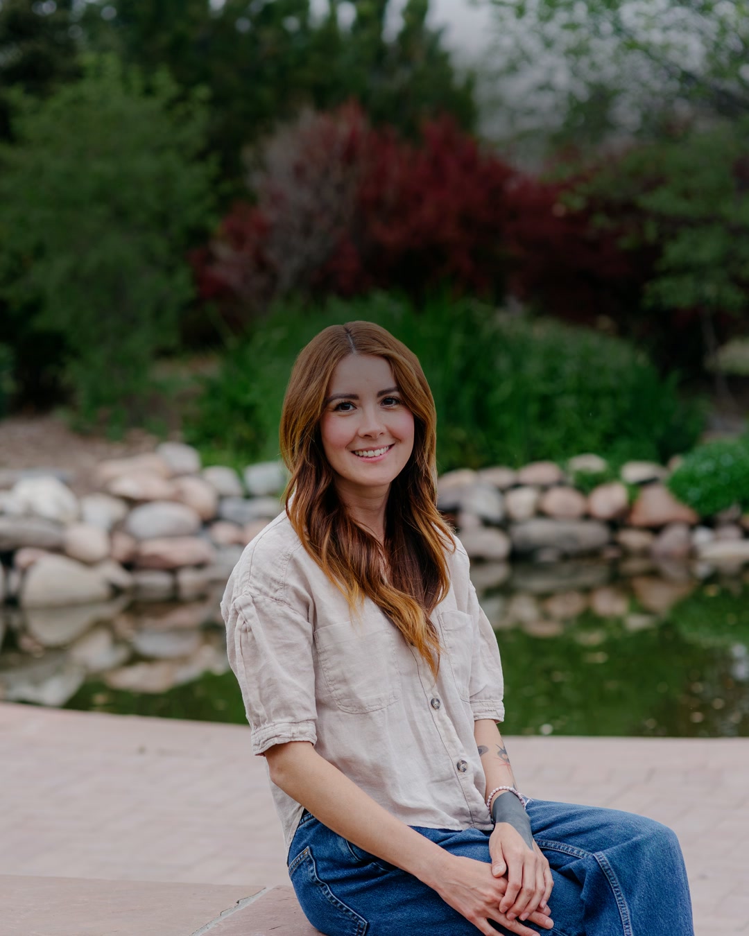 Wendy seated by the pond